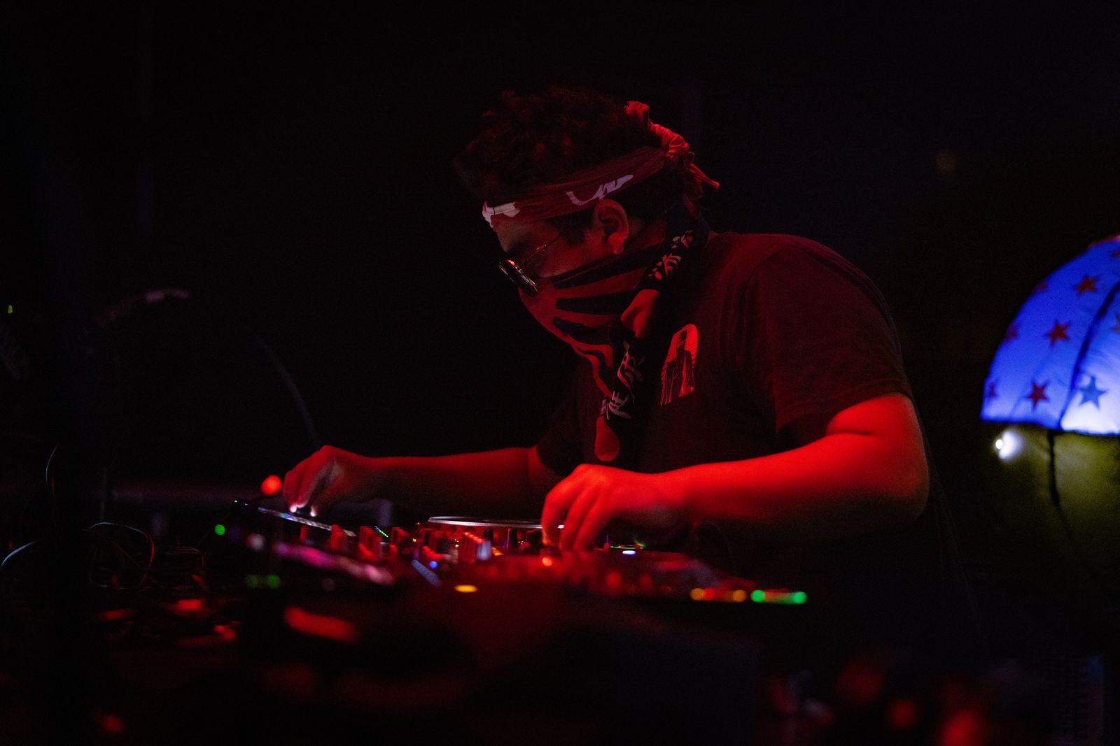 DJ behind the decks in red light