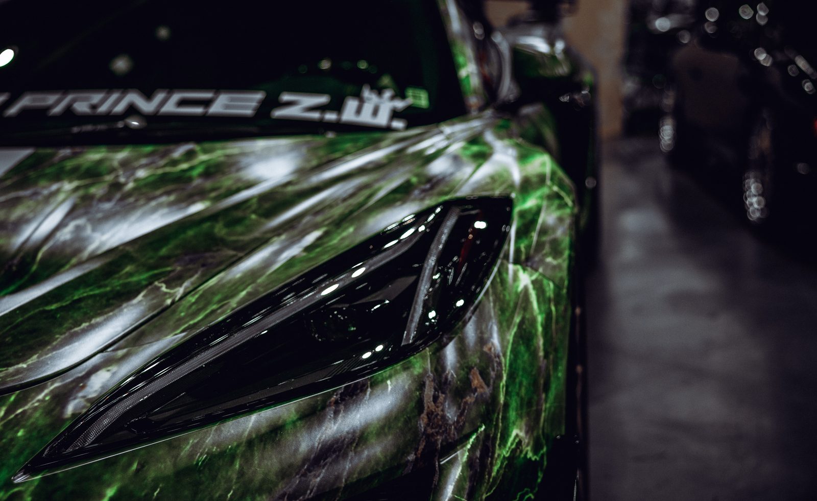 Close detail of a custom-wrapped supercar headlight
