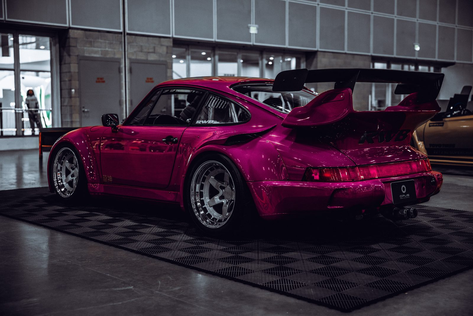 Pink RWB Porsche photographed from the rear three-quarter