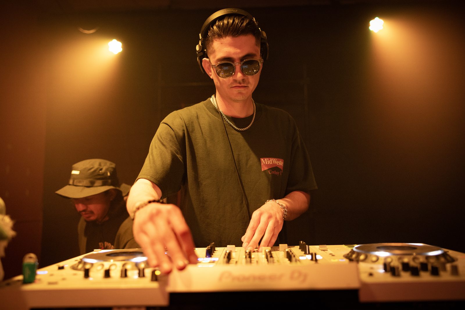 Performer lit in warm stage light during a live set
